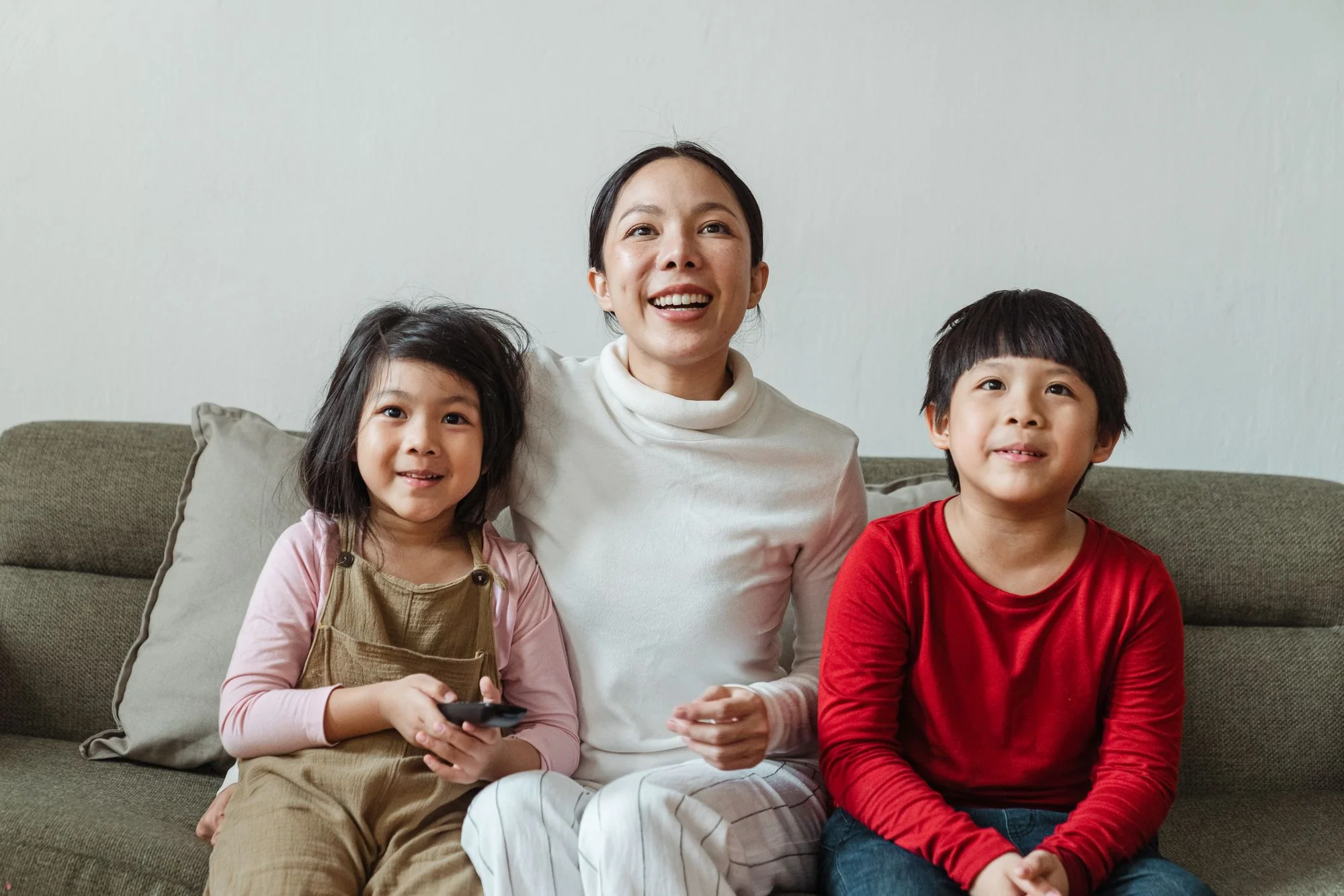 Family watching TV together at home
